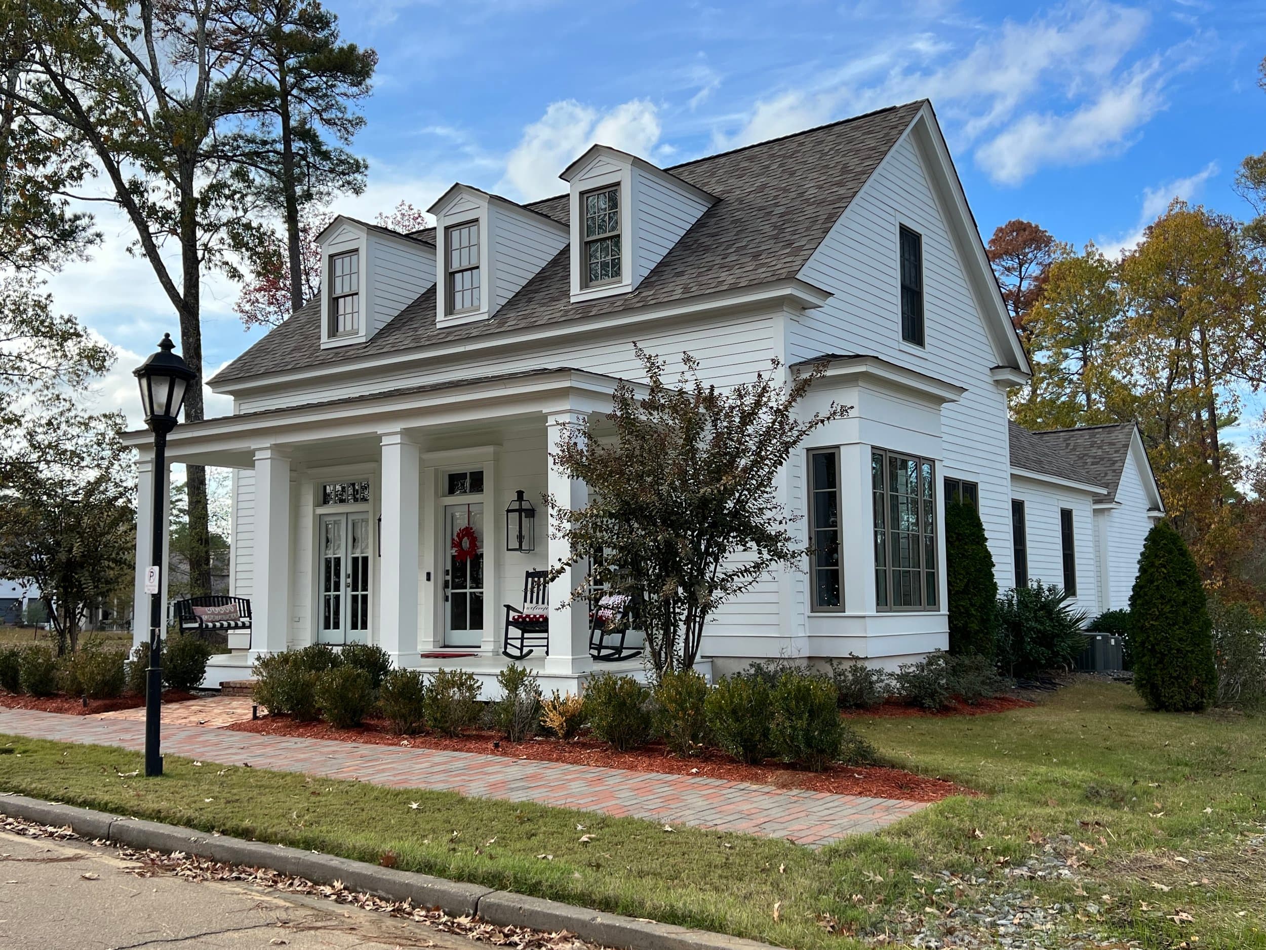 Two-story house with front porch in autumn